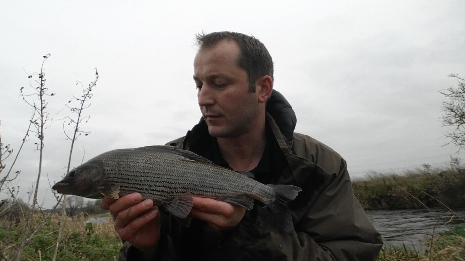 angler holds large grayling
